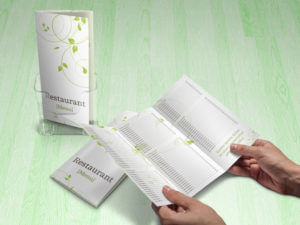 green swirls tri-fold menu holding